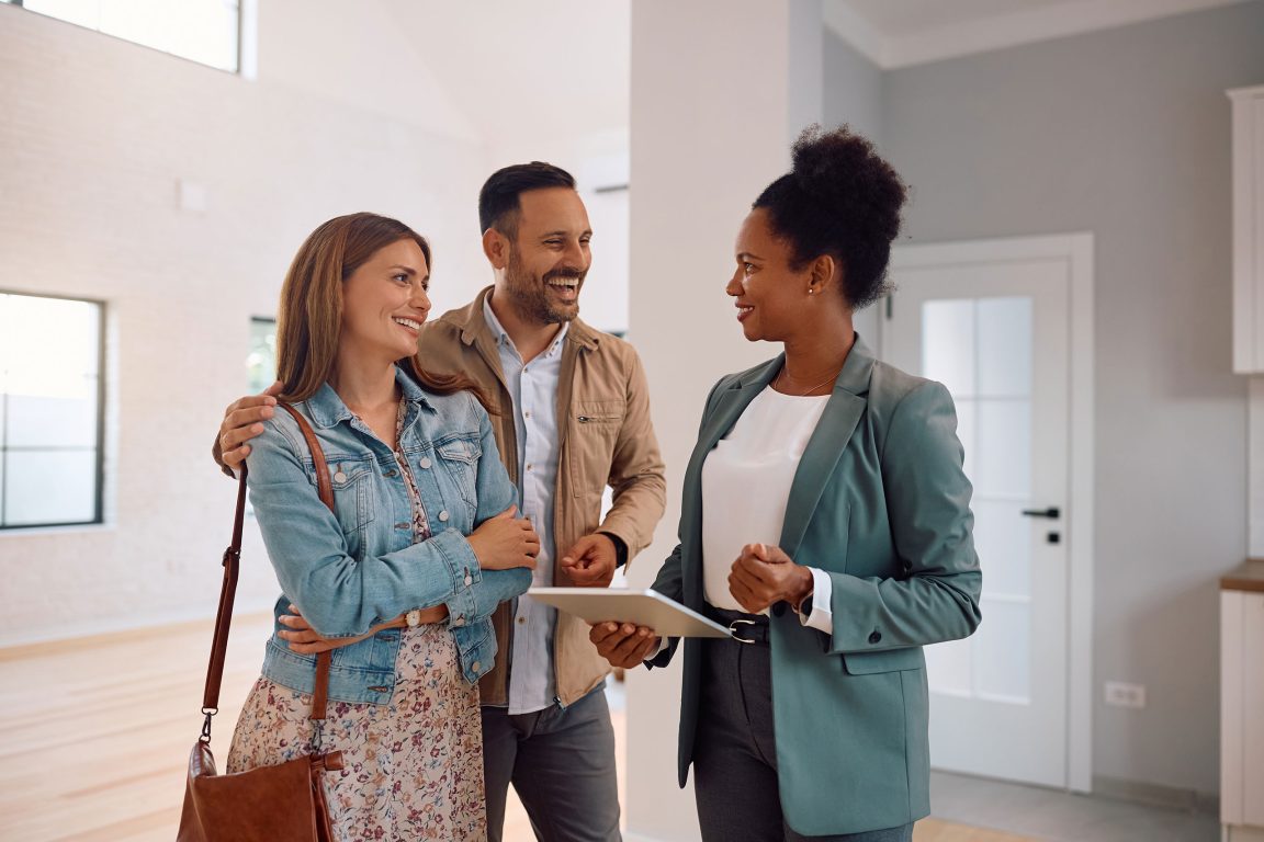 Happy couple with a real estate agent