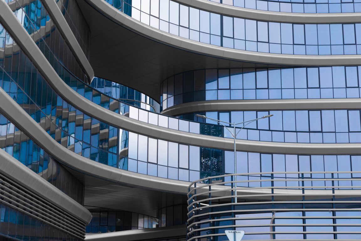 Stylish office building with blue glass and aluminum