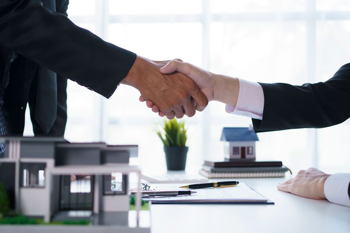lawyer shaking hands over real estate deal